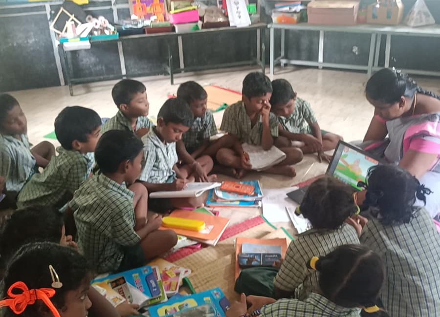 Children working together in groups on the classroom floor
